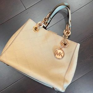 Nude Michael Kors handbag with rose gold trim.